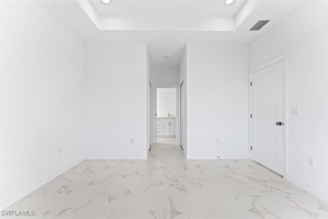 empty room featuring a tray ceiling