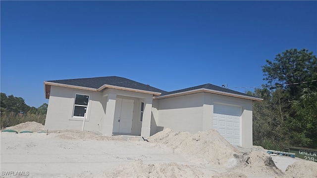 2618 25th St W, Lehigh Acres, FL 33971 - view of front of property featuring a garage and stucco siding