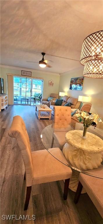 dining area with crown molding, ceiling fan, and hardwood / wood-style flooring