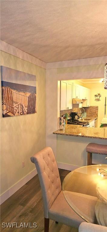 dining area with dark hardwood / wood-style flooring