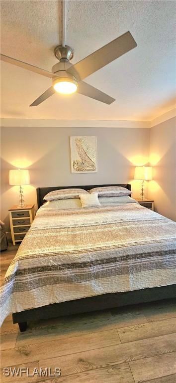 bedroom with hardwood / wood-style floors and ceiling fan