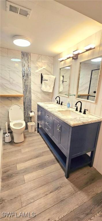 bathroom featuring hardwood / wood-style flooring, vanity, and toilet