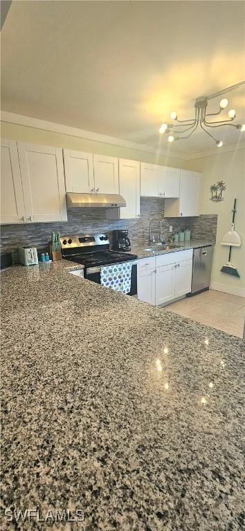 kitchen featuring stone counters, white cabinetry, sink, and appliances with stainless steel finishes