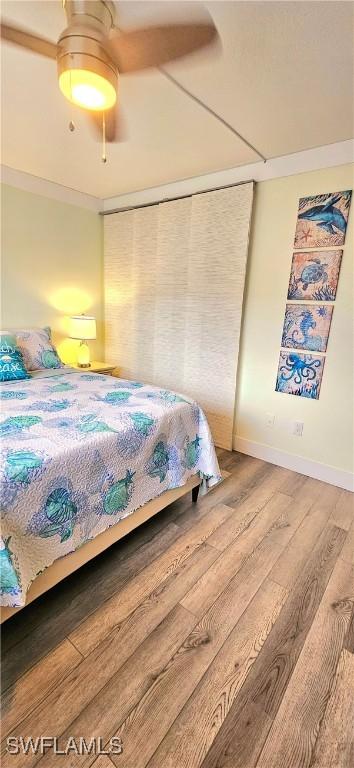 bedroom with hardwood / wood-style floors and ceiling fan