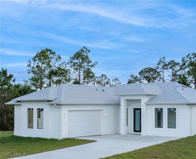 view of front of house with a garage and a front yard