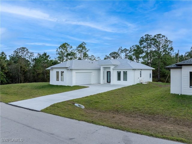 view of front of home with a front lawn and a garage