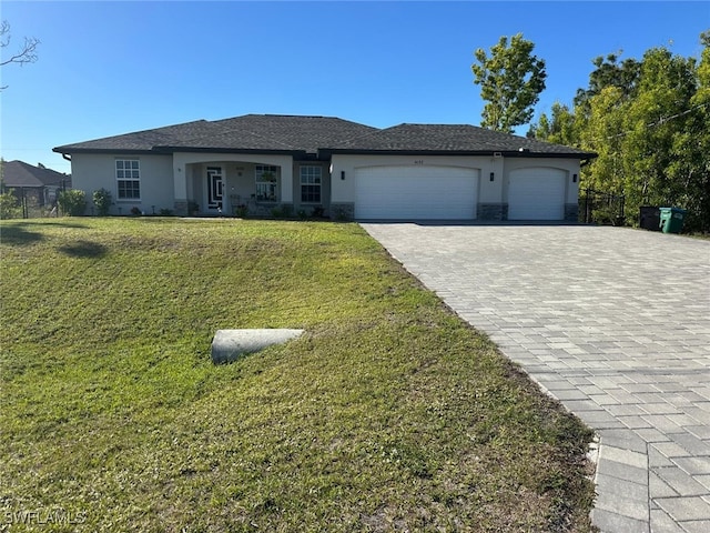 view of front of home with a front yard and a garage