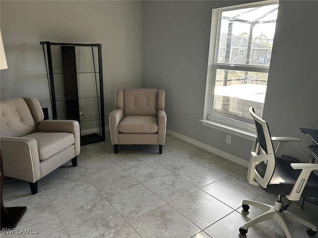 office space featuring plenty of natural light and light tile patterned flooring