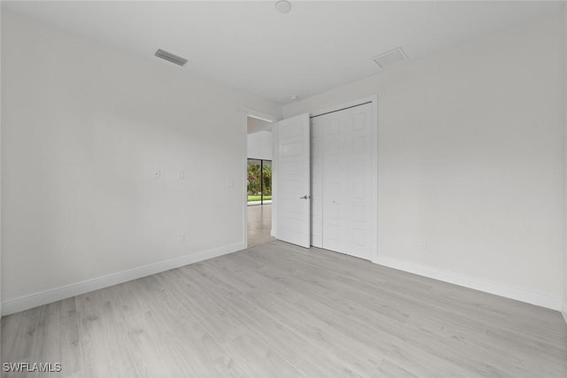 spare room with light hardwood / wood-style floors