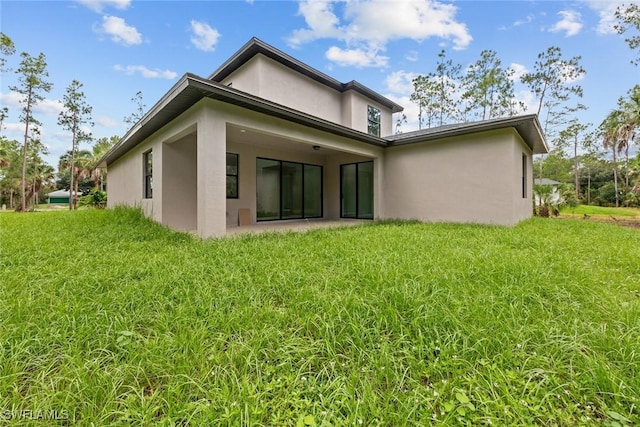 rear view of house with a lawn