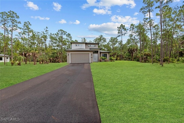 view of front of property featuring a garage and a front lawn