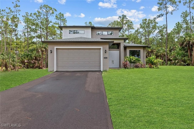 view of front of home with a garage and a front lawn