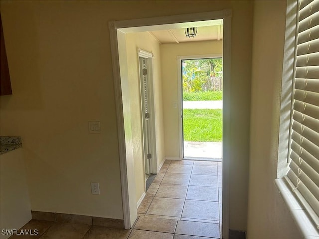 doorway with light tile patterned flooring