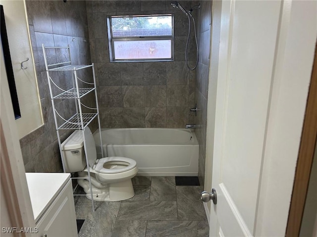 full bathroom with vanity, tile patterned flooring, tiled shower / bath combo, toilet, and tile walls