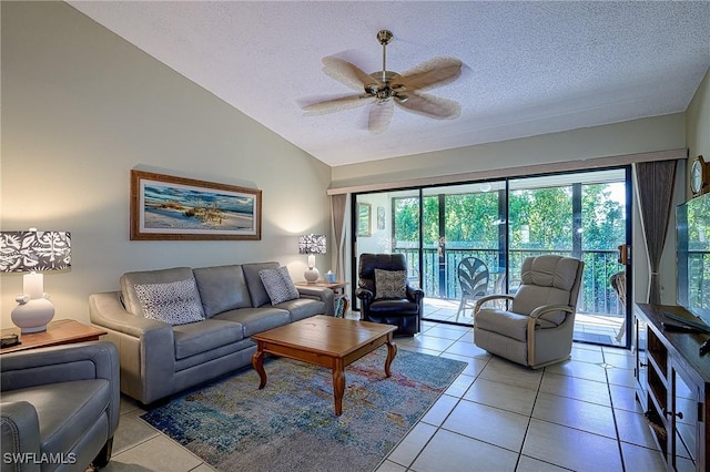 living room featuring a textured ceiling, vaulted ceiling, ceiling fan, and light tile patterned flooring