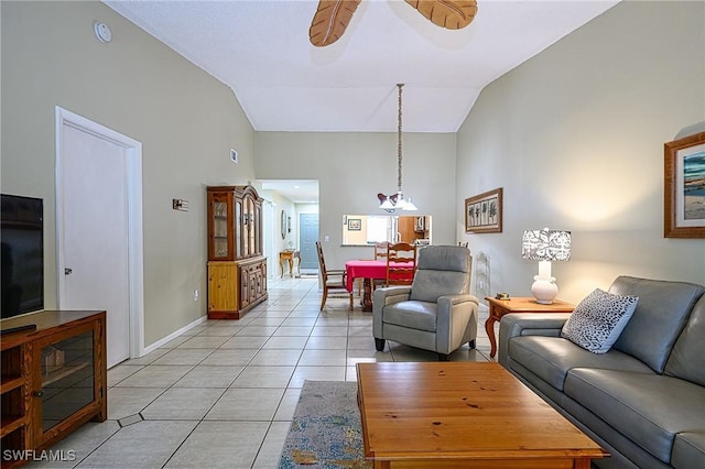 living room with ceiling fan, lofted ceiling, and light tile patterned flooring