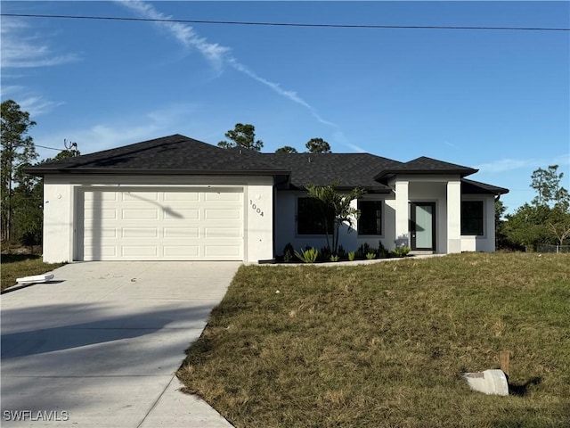 view of front of house featuring a front lawn and a garage