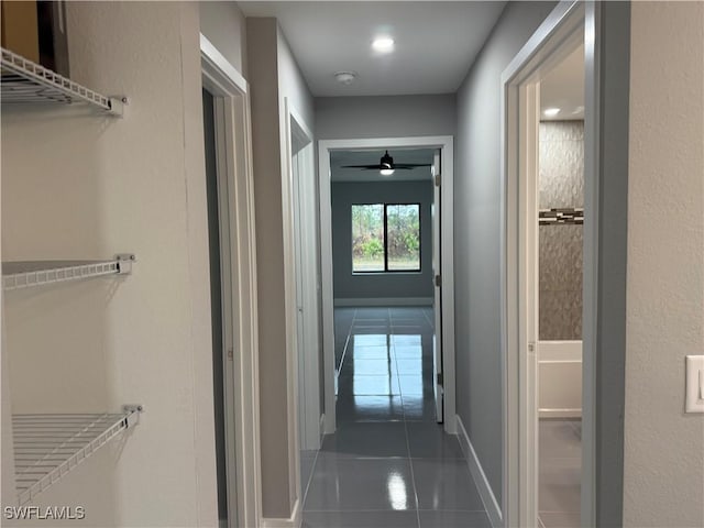 corridor featuring dark tile patterned flooring