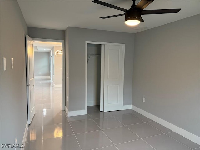 unfurnished bedroom with ceiling fan, a closet, and tile patterned floors