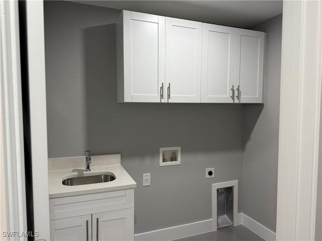 clothes washing area with cabinets, sink, hookup for a washing machine, and hookup for an electric dryer