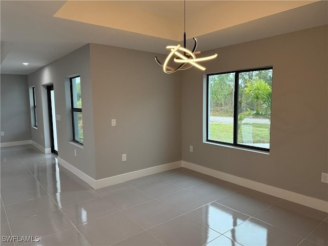 unfurnished room with light tile patterned floors and a notable chandelier