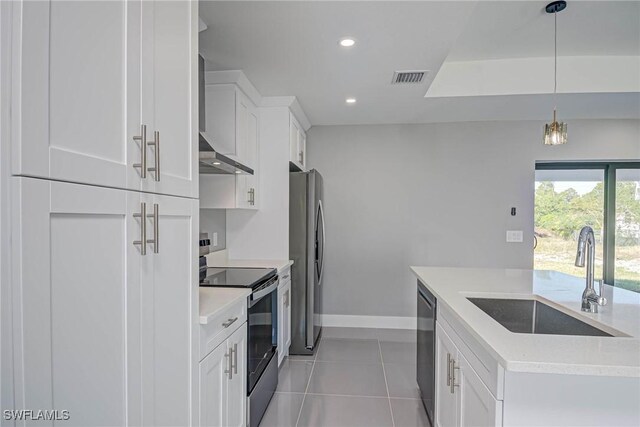 kitchen with white cabinetry, appliances with stainless steel finishes, sink, and pendant lighting