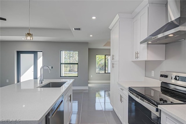 kitchen with sink, stainless steel appliances, white cabinets, and wall chimney exhaust hood