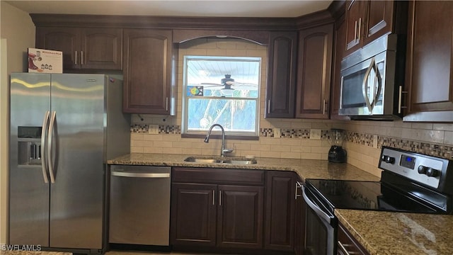 kitchen featuring sink, stainless steel appliances, and dark brown cabinets