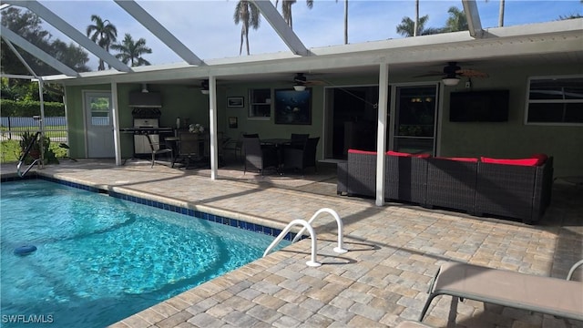 view of swimming pool featuring outdoor lounge area, a patio, and glass enclosure