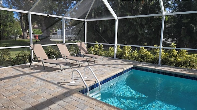 view of pool with a lanai and a patio