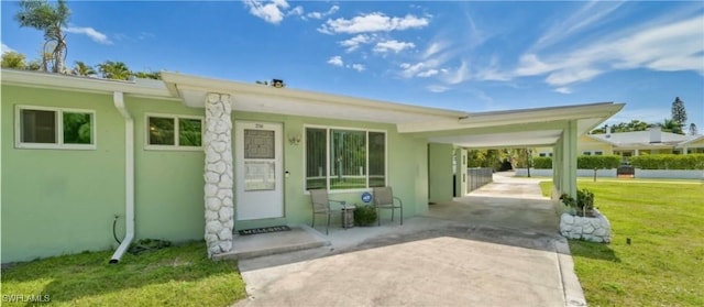 exterior space with a carport and a yard