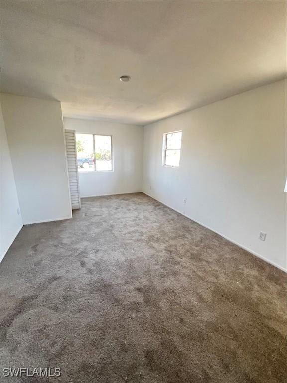 carpeted empty room with plenty of natural light