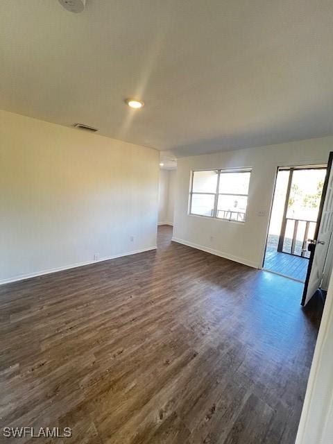 unfurnished room featuring dark wood-type flooring