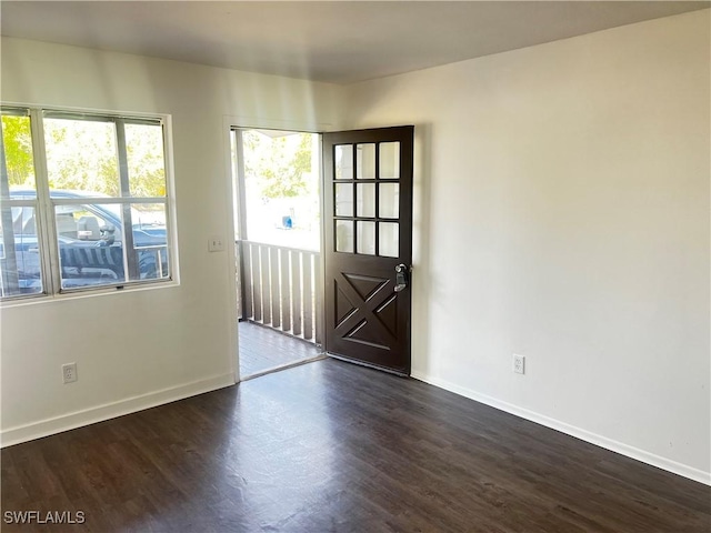 spare room with dark wood-type flooring