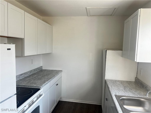 kitchen featuring white fridge, stove, dark hardwood / wood-style flooring, white cabinets, and sink