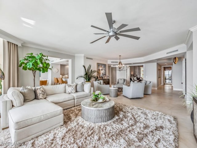 living room with ceiling fan with notable chandelier and crown molding