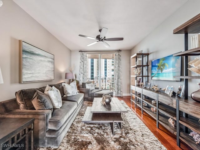 living room featuring dark hardwood / wood-style flooring and ceiling fan