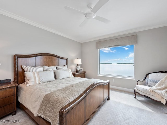 carpeted bedroom with ceiling fan, a water view, and crown molding