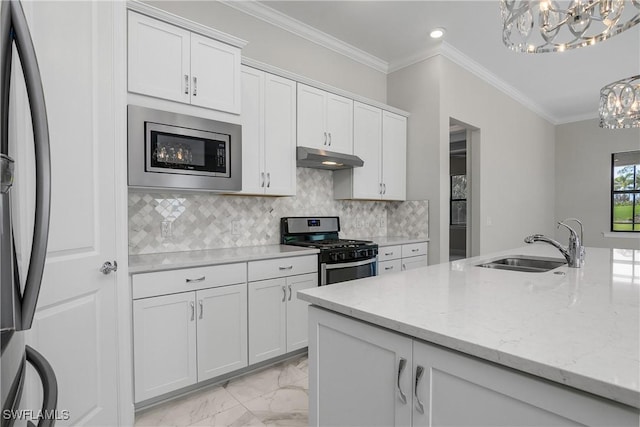 kitchen featuring sink, white cabinets, backsplash, stainless steel appliances, and light stone countertops