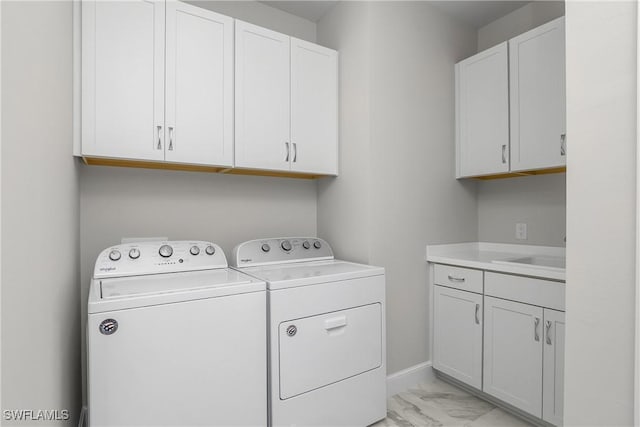 washroom featuring cabinets, washer and dryer, and sink