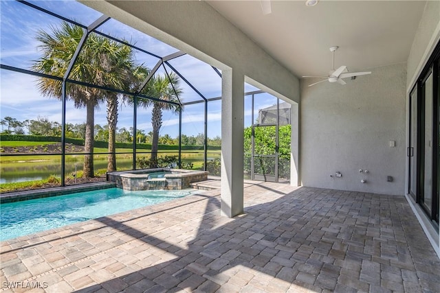 view of swimming pool featuring pool water feature, a water view, glass enclosure, an in ground hot tub, and a patio