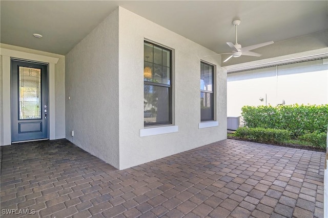 doorway to property featuring ceiling fan and a patio area