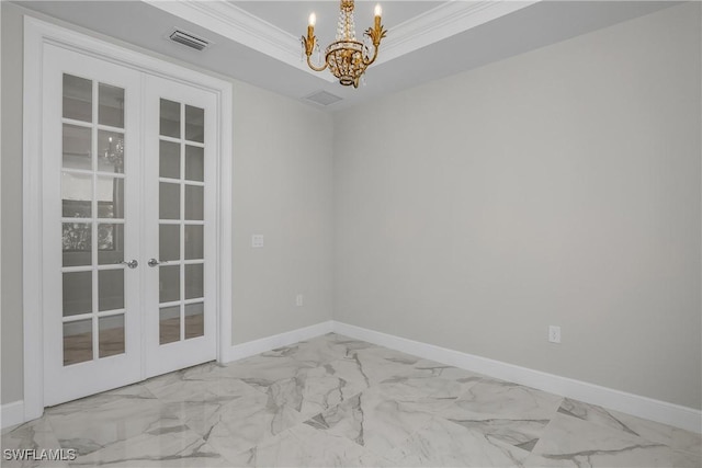 unfurnished room with french doors, ornamental molding, a raised ceiling, and a notable chandelier