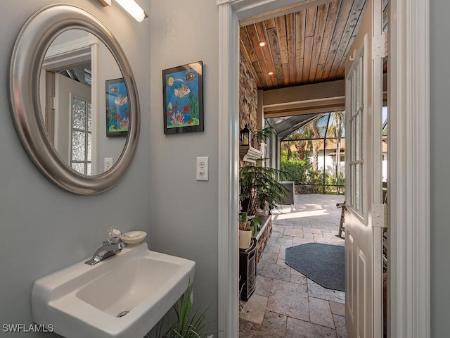 bathroom featuring sink and wood ceiling