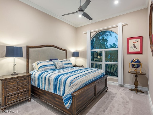 carpeted bedroom featuring ceiling fan and ornamental molding