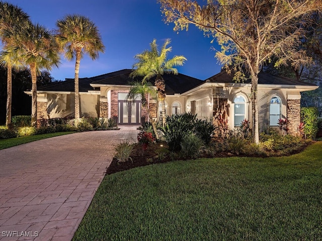 view of front facade with french doors and a front yard