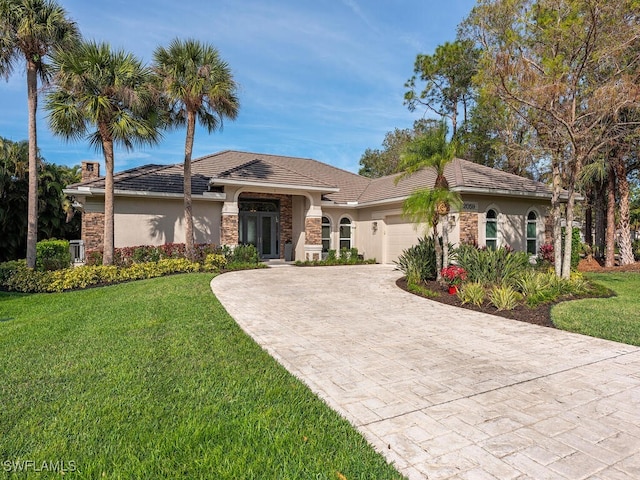 view of front of house with a garage and a front lawn