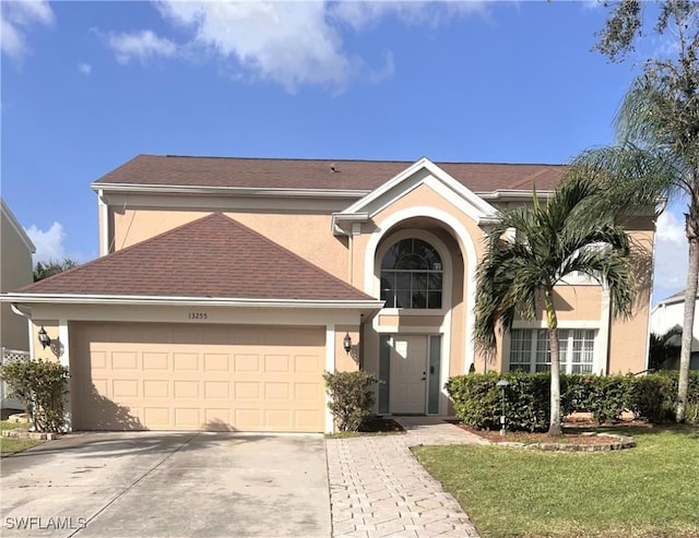 view of front of property with a garage and a front yard