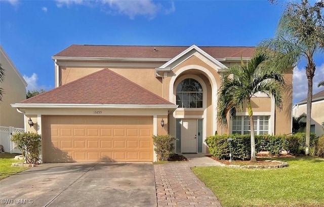 view of front of home featuring a garage and a front lawn