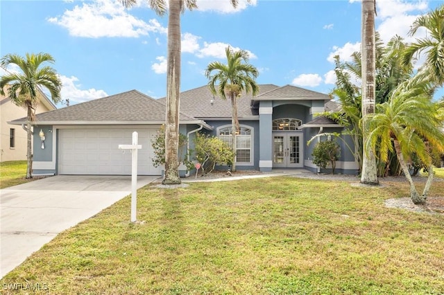 view of front of house featuring a front lawn, a garage, and french doors